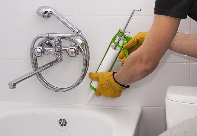 Sealant applied along bathtub and tiled wall joint